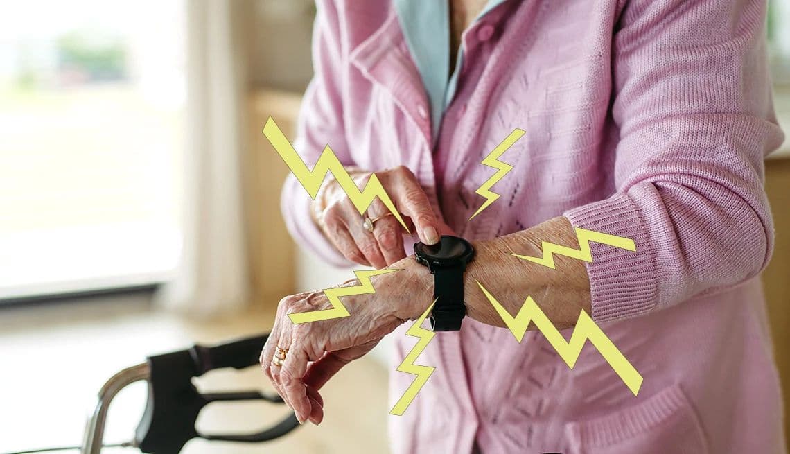 An older adult wearing a medical alert pendant in a calm home setting, illustrating independent living with a personal emergency response device.