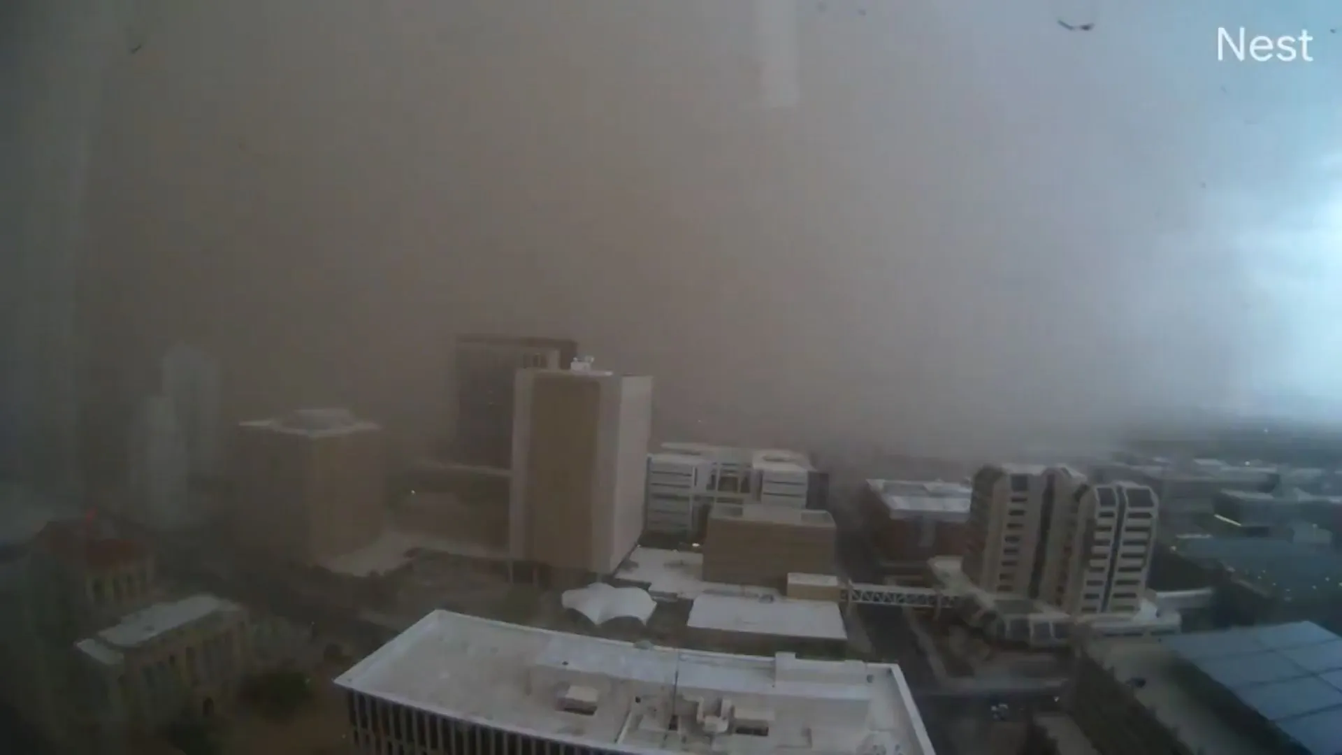 A towering brown wall of dust sweeping over downtown Phoenix and reducing visibility