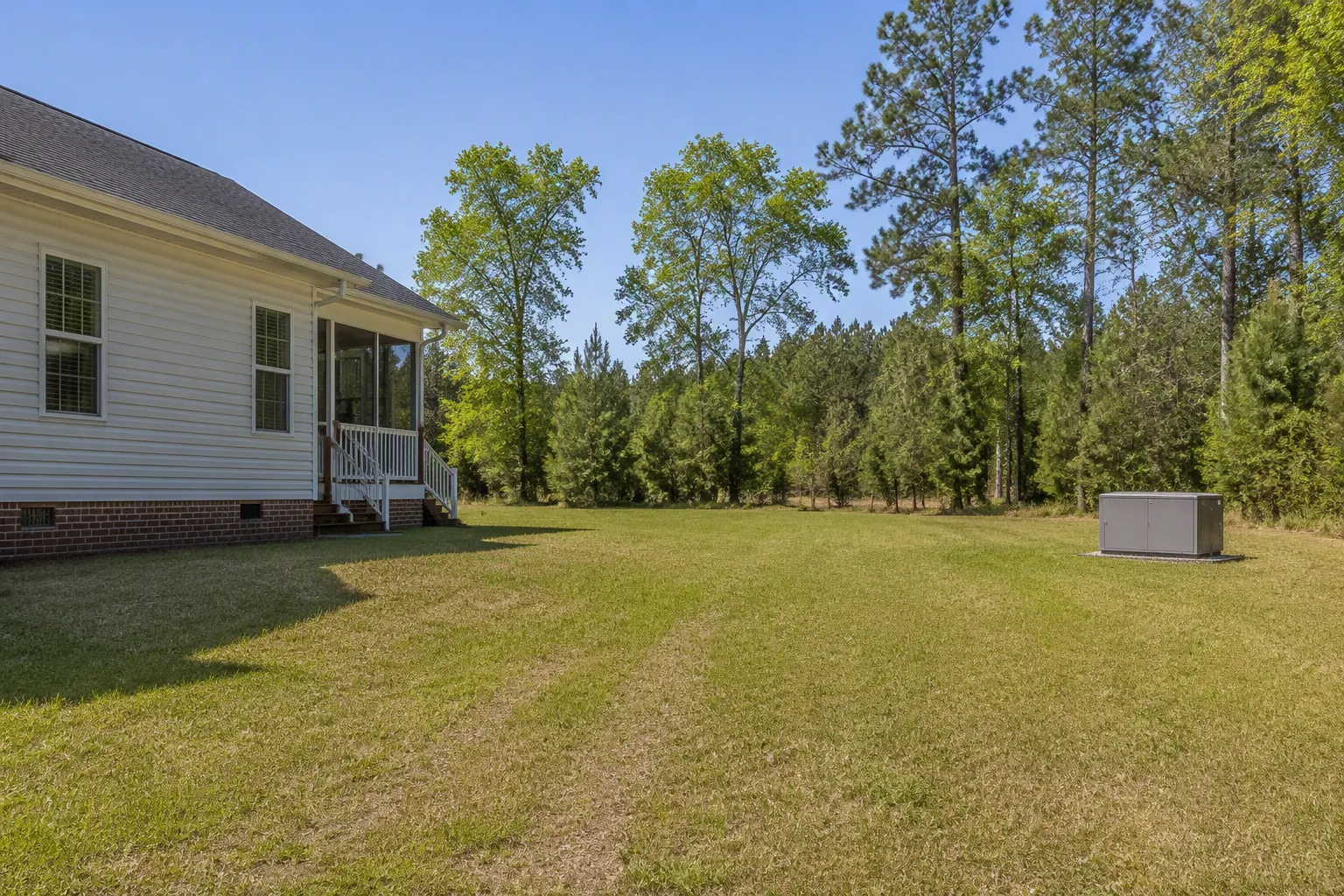 Portable generator placed far from a suburban home across an open yard