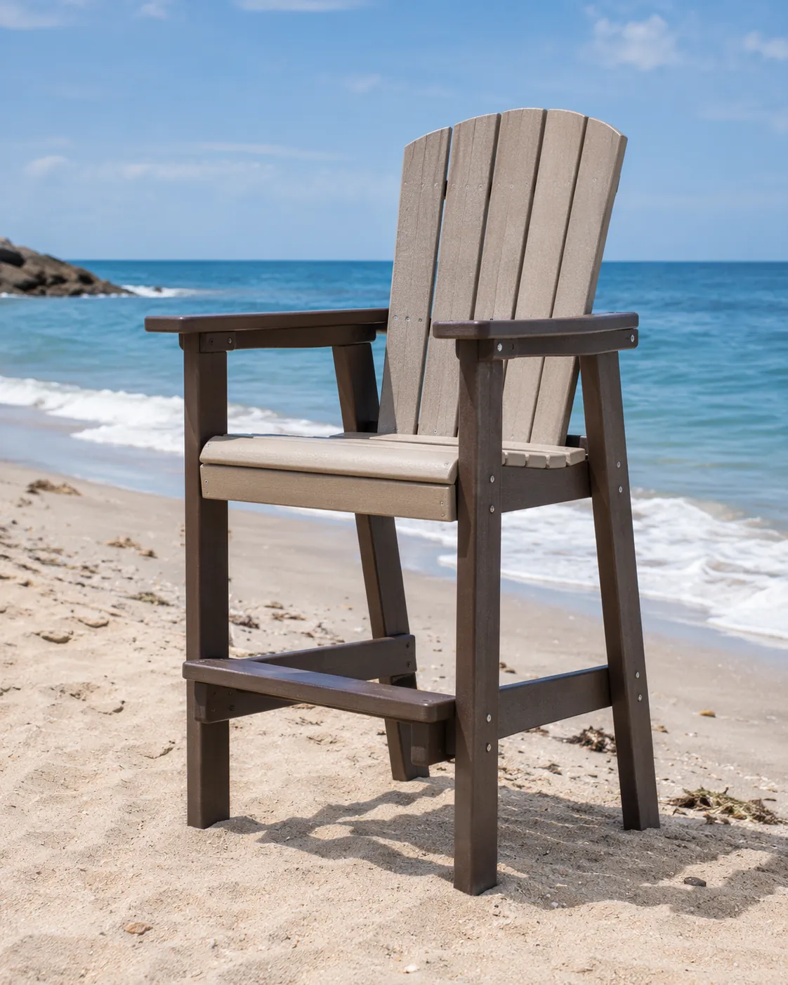 Tall beach chair with sturdy armrests placed on sand near the shoreline