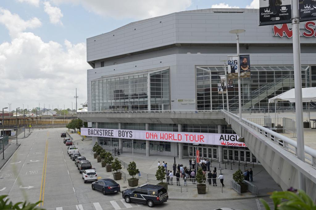 Smoothie King Center in New Orleans with evacuation buses lined up outside