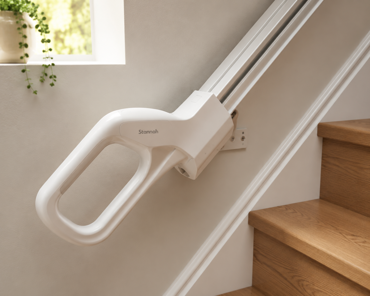 White stair climbing aid handle mounted on a wooden staircase rail