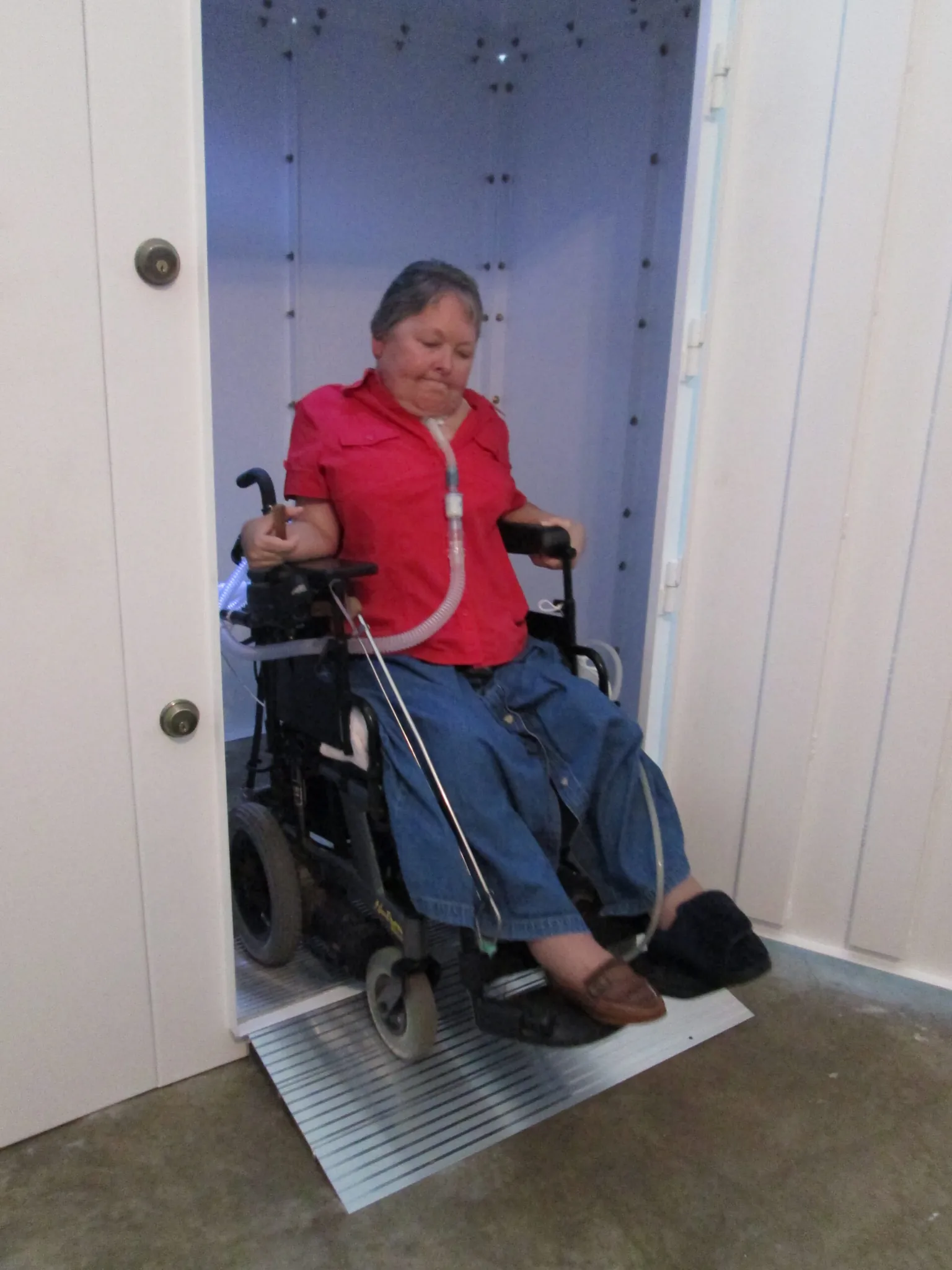 Above-ground steel tornado safe room with wheelchair ramps and wide accessible door