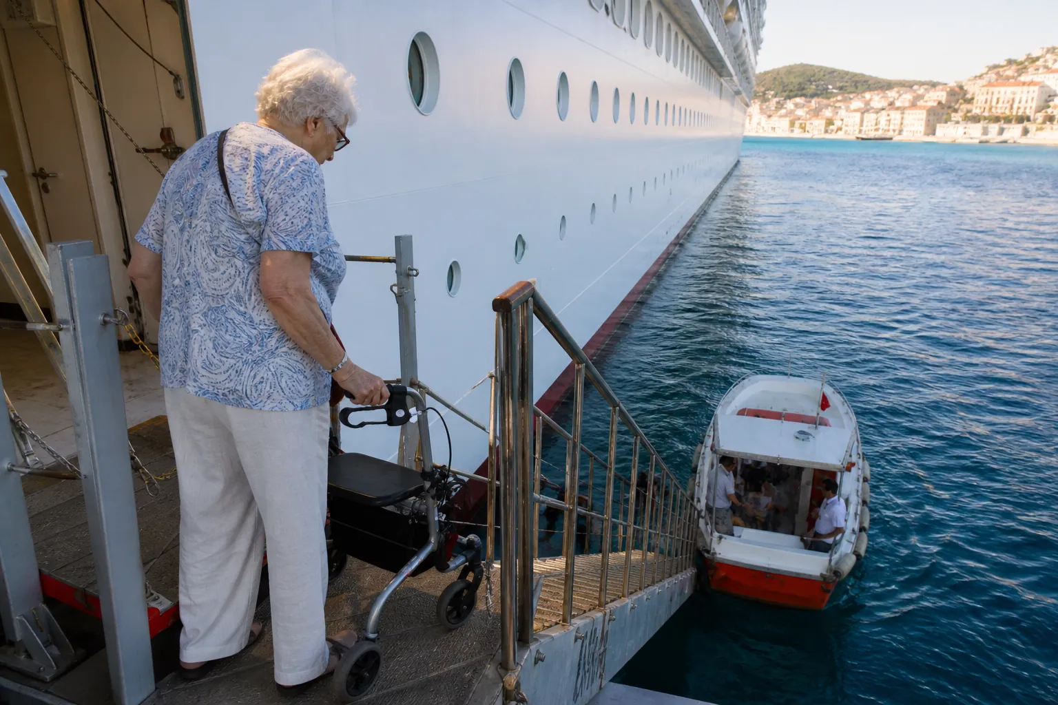 Elderly passenger with a rollator facing a steep gangway down to a rocking tender boat
