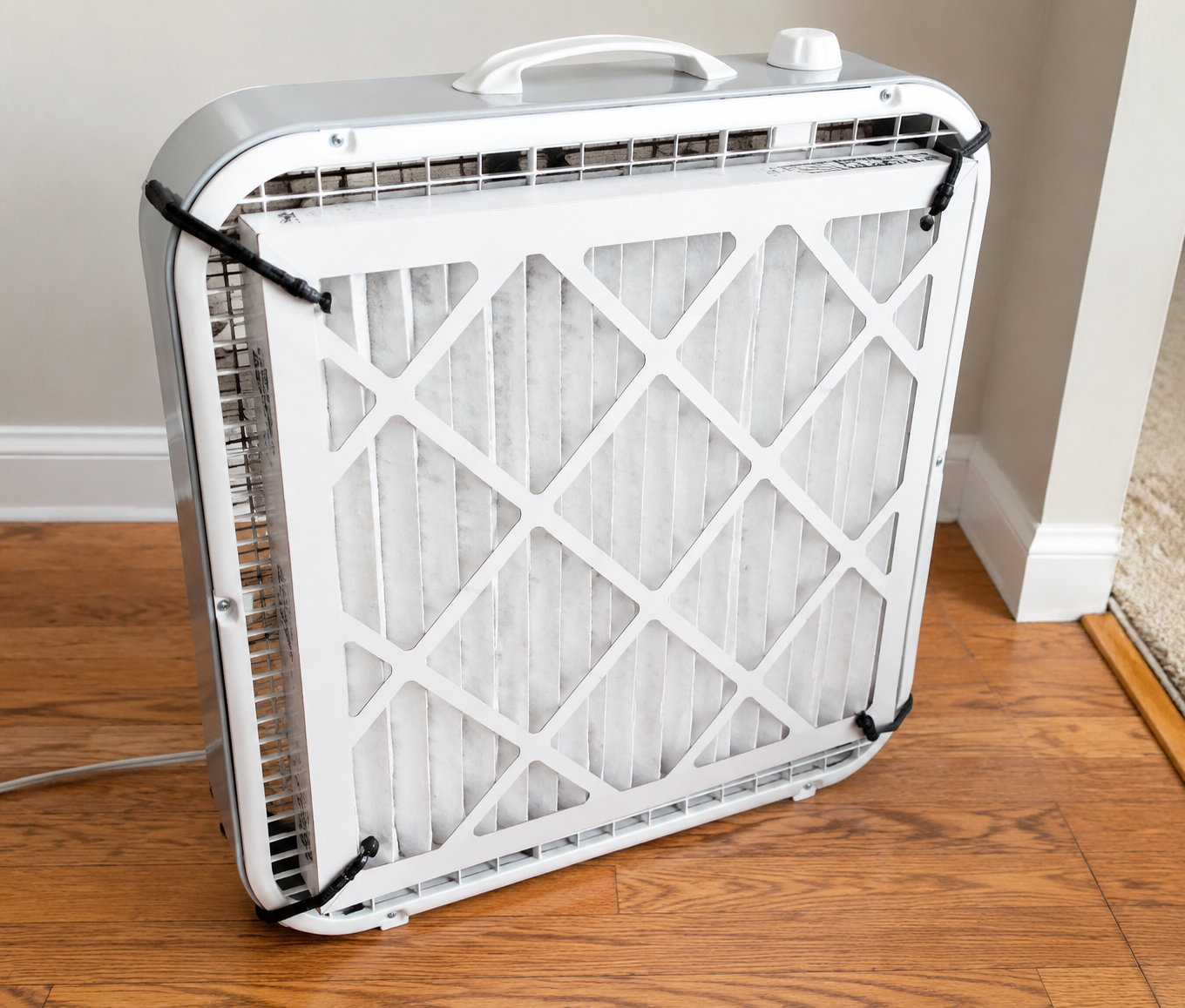Box fan with a MERV-13 furnace filter attached to the intake side for a DIY indoor air cleaner